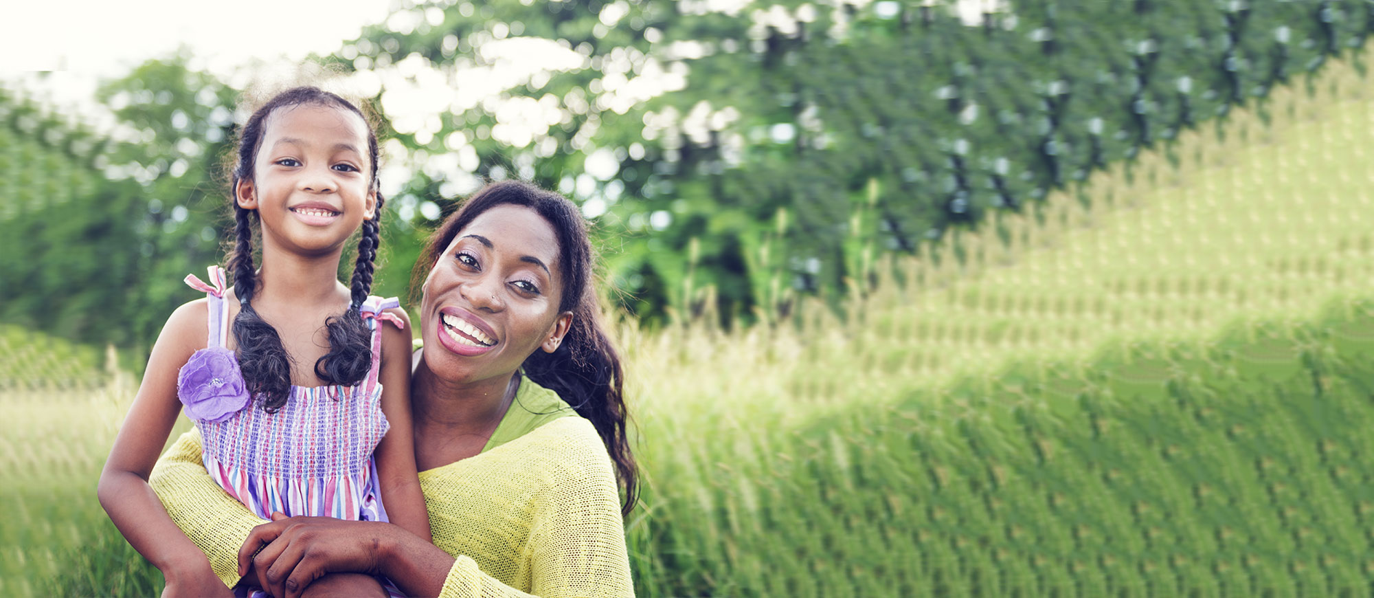Mother and daughter in field of grass
